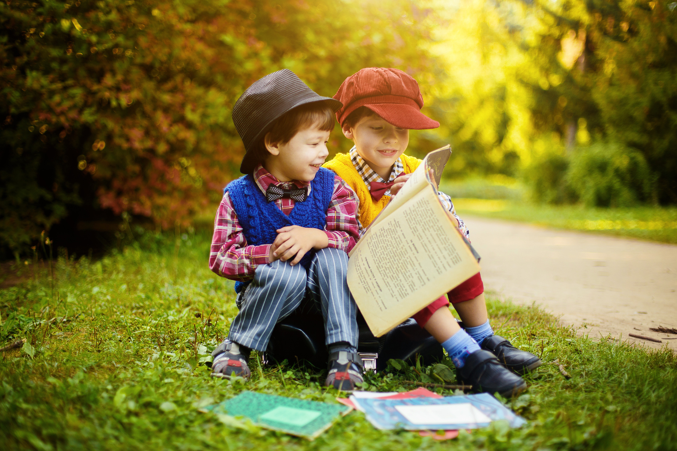 Two Boys Reading Books in the Park